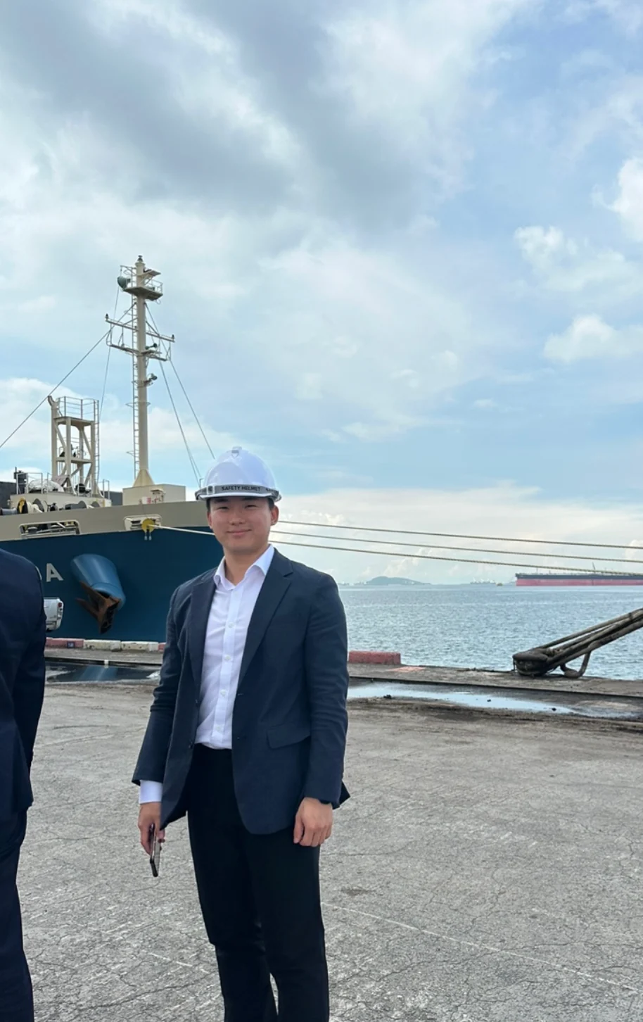 Danny Park wearing a safety helmet and suit at a port